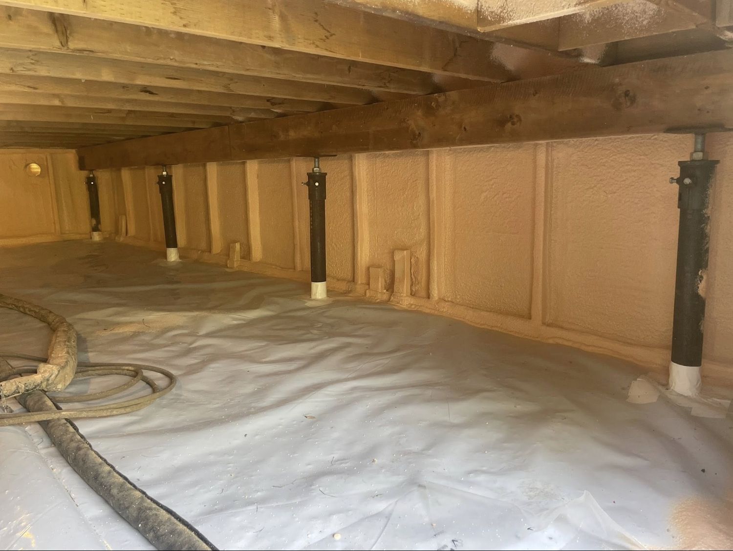 Crawl space with perimeter walls fully spray foamed and finished