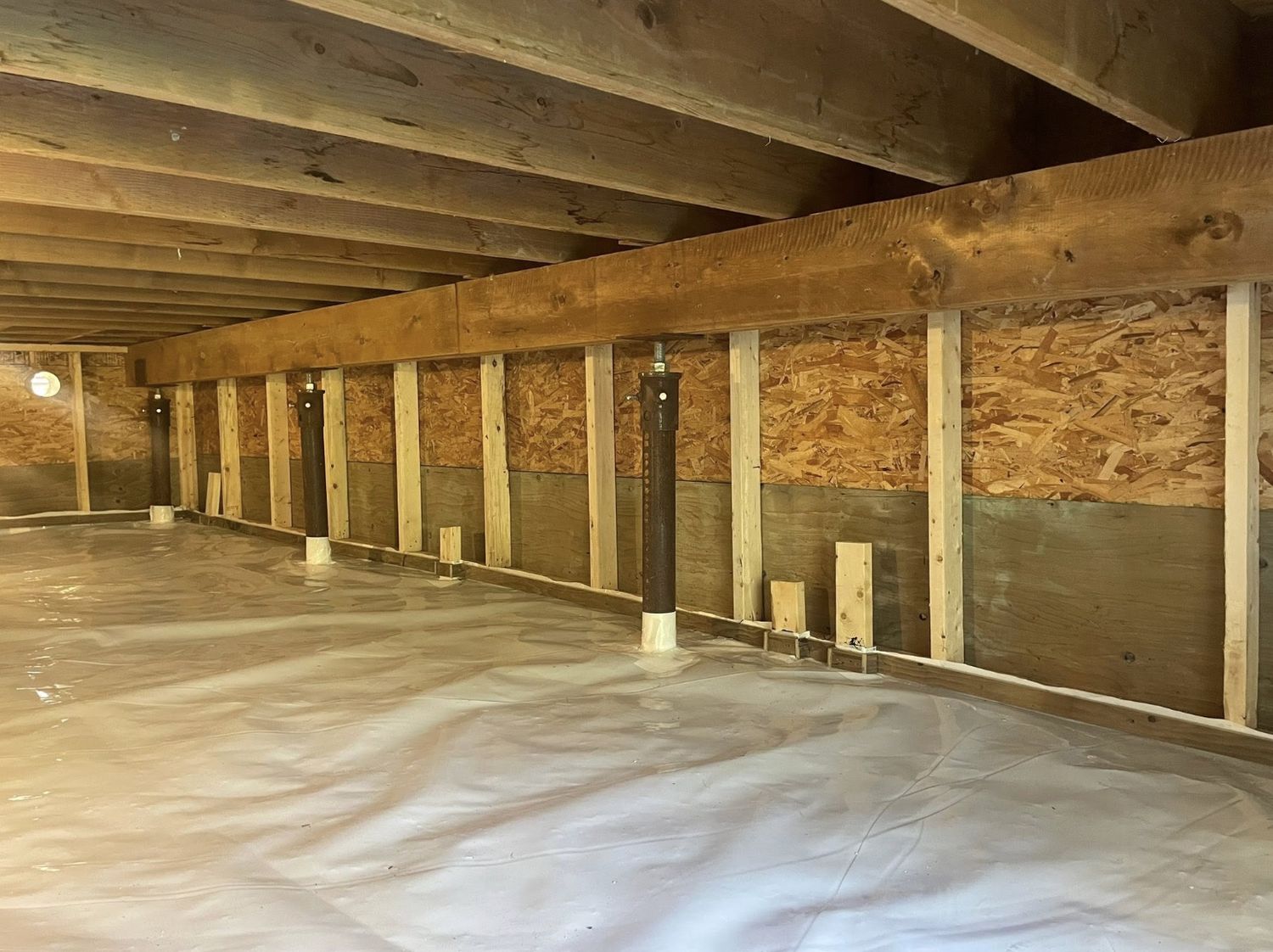 Crawl space prepared and masked off before spray foam application