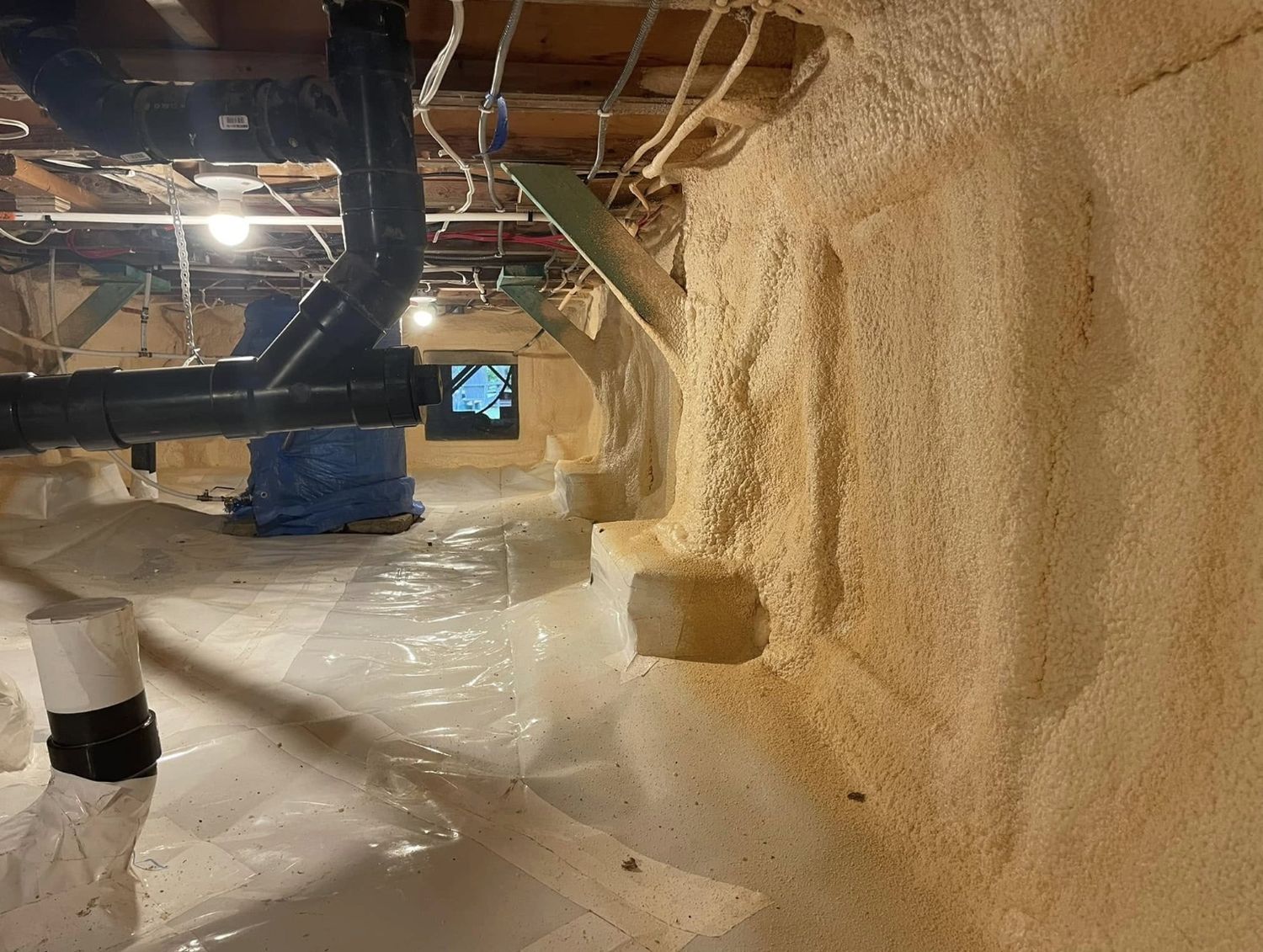 Crawl space with a thick spray foam application sealed at the poly vapour barrier